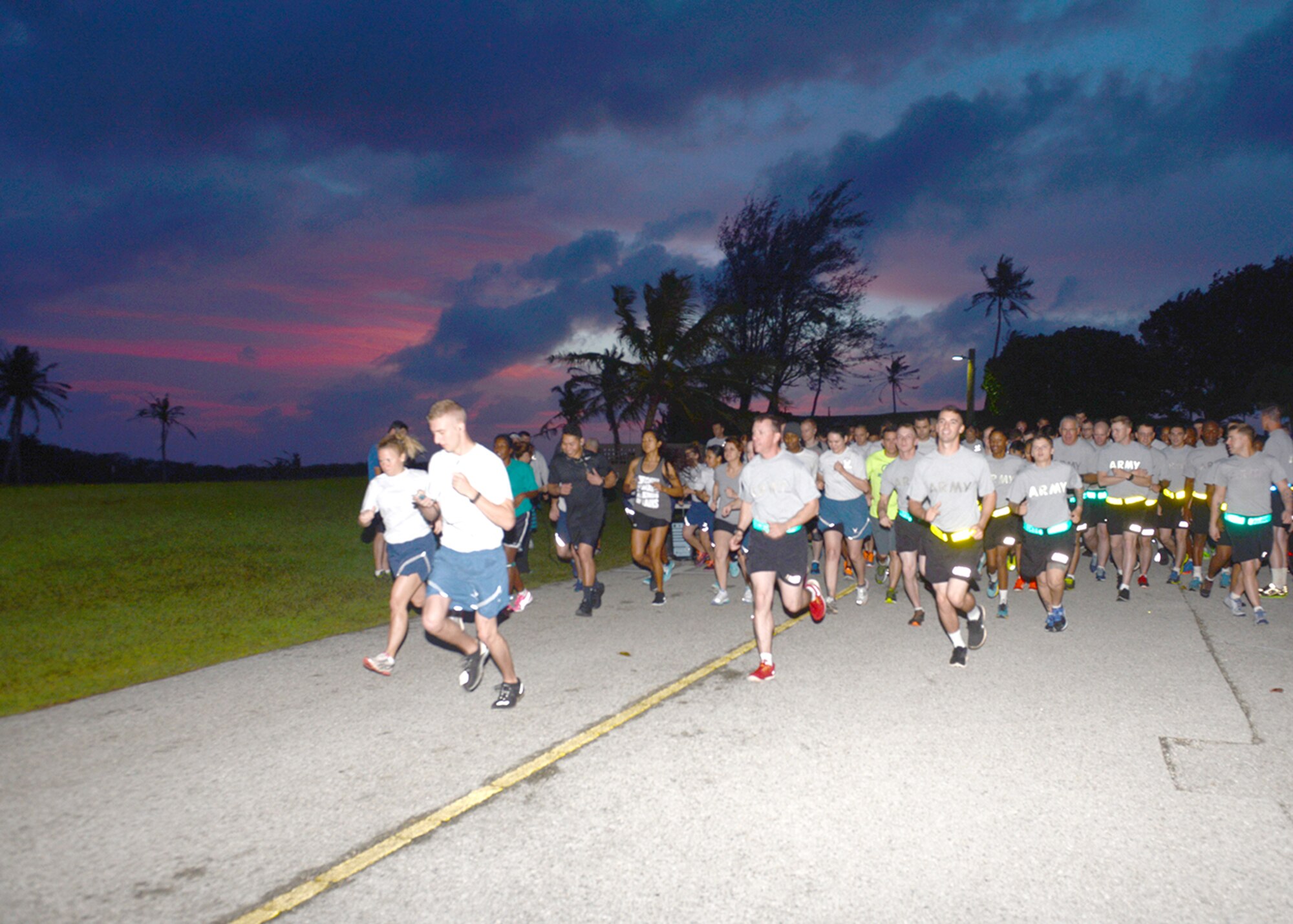 Team Andersen members get the New Year’s Hustle 5K run started during the pre-dawn hours Jan. 14, 2015 at Andersen Air Force Base, Guam. Nearly 100 Andersen Airmen, U.S. Army Soldiers from Task Force Talon, civilians and family members took part in the run that required runners to run from the Palm Tree Golf Course Driving Range to the Guam Air National Guard’s 254th RED HORSE Squadron headquarters and back. (U.S. Air Force photo by Tech. Sgt. Zachary Wilson/Released.)