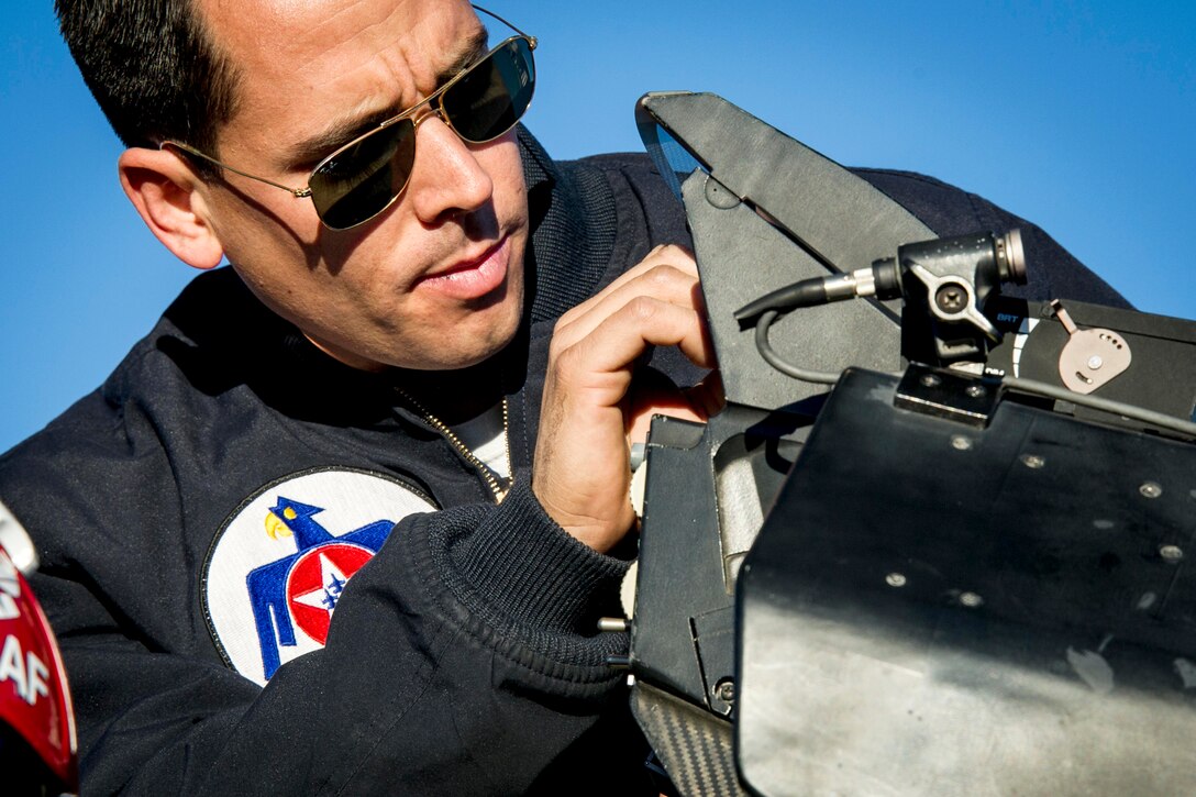 Air Force Staff Sgt. Andrew Molina prepares his jet before the Thunderbirds pilots perform their first delta formation on Nellis Air Force Base, Nev., Jan. 13, 2015. Molina is an assistant crew chief assigned to the Air Force Thunderbirds air demonstration team. 