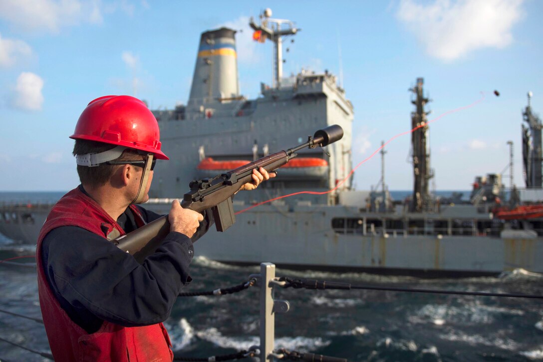 U.S. Navy Petty Officer 2nd Class Donovan R. Luce fires a shot-line from the guided-missile destroyer USS Dewey to Military Sealift Command fleet replenishment oiler USNS Walter S. Diehl during a replenishment at sea in the U.S. 5th Fleet area of operations, Jan. 11, 2015, supporting Operation Inherent Resolve. Luce is a gunner’s mate.