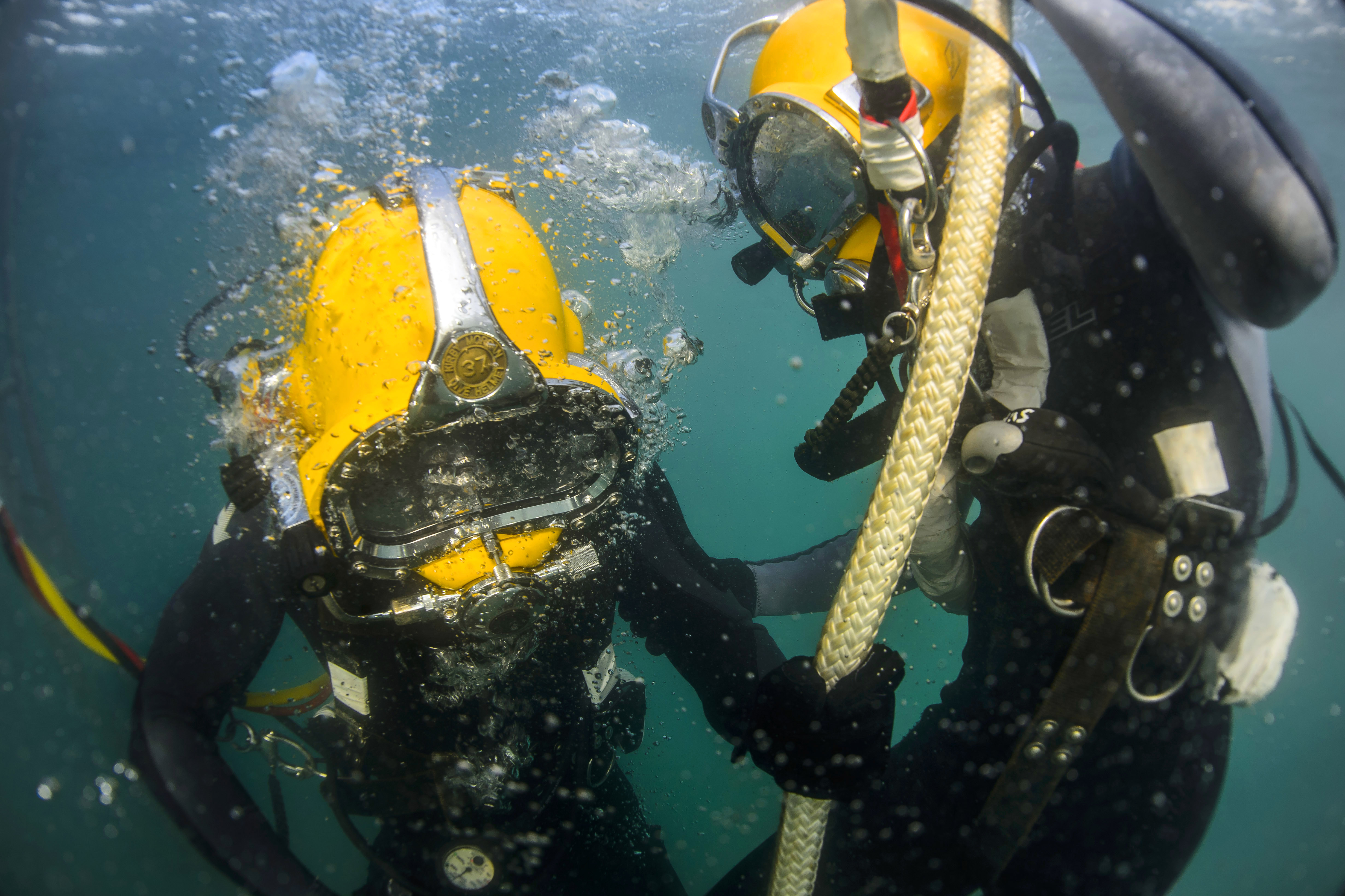 Navy seabee divers conduct surface supplied diving operations during diver training on Naval Air