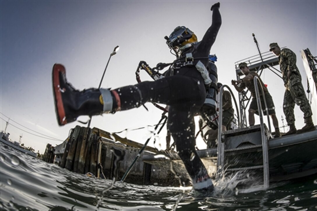A Navy Seabee diver performs a front-step water entry during diver training on Naval Air Station Key West, Fla. Jan. 13, 2015. The two-week training is an evolution between Underwater Construction Team One and Underwater Construction Team Two.