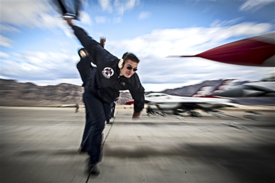 Air Force Staff Sgt. Sean Gilbert races to recover a Thunderbirds jet after conducting the year's first delta formation on Nellis Air Force Base, Nev., Jan. 13, 2015. Molina is an an avionics systems specialist assigned to the Air Force Thunderbirds air demonstration team.