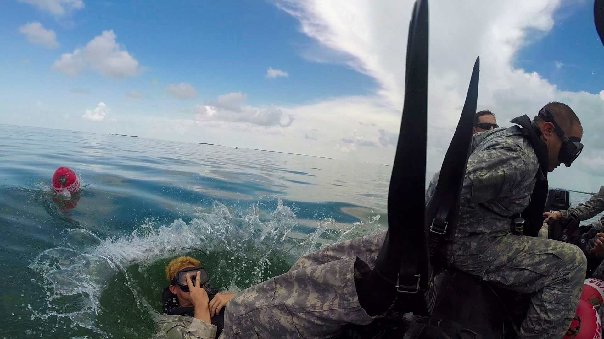 A Soldier from 20th Special Forces Group, Army National Guard, performs a back roll entry into the water during training and re-certification at the U.S. Army Special Forces Underwater Operations School, June 22, 2014 in Key West, Florida. Even after their initial training to be part of Special Forces, Soldiers - known as Green Berets - must continue to attend schools and train just to maintain proficiency in their specialty skill sets, like combat diver.