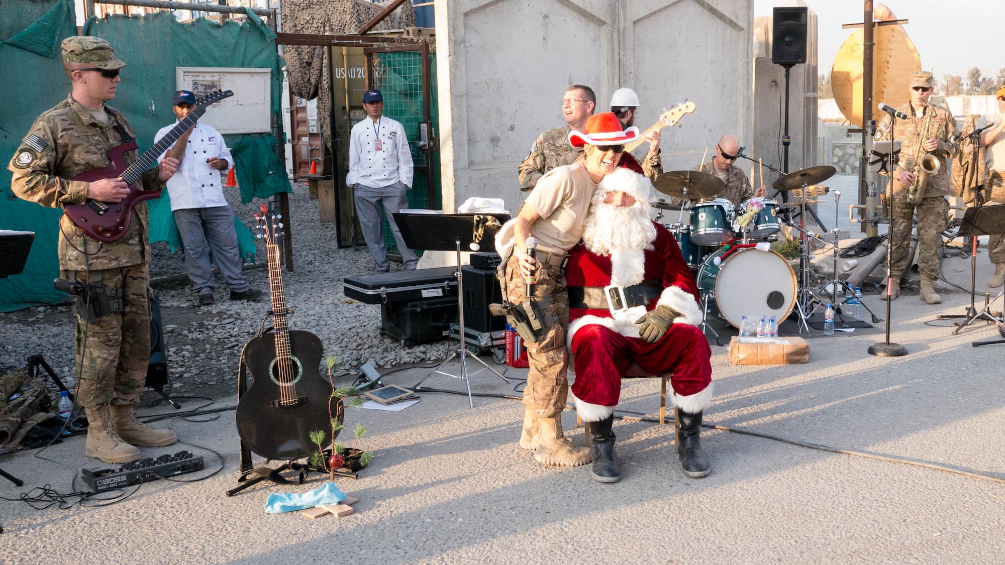 Tech. Sgt. Krista Joyce (right) and Staff Sgt. Jesse Thompson of the U.S. Air Forces Central Command Band join a visiting Santa Clause at Forward Operating Base FENTY, Afghanistan, on Dec 25, 2014. Pegasus in collaboration with the USO performed six hours worth of music over the course of a holiday celebration complete with food and free gifts to raise the spirits of deployed servicemen and women. (Courtesy Photo)
