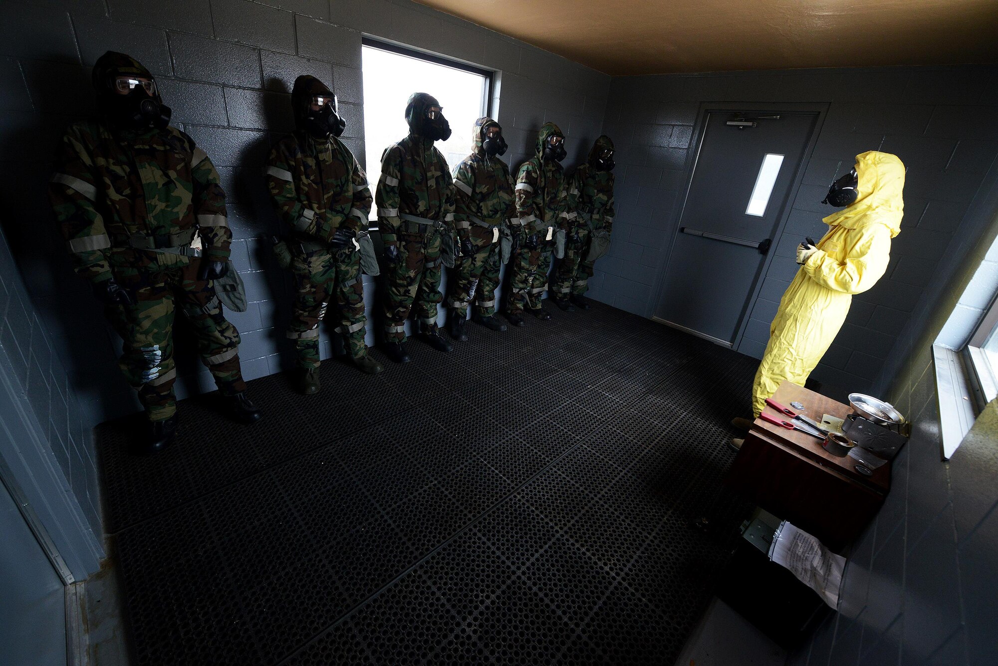 Staff Sgt. Heidi Williams, 47th Civil Engineer Squadron emergency management technician, briefs trainees during the chemical, biological, radiological, and nuclear survival skills class at the confidence chamber on Laughlin Air Force Base, Texas, Jan. 14, 2015. Class attendees are educated on how to use a protective mask and how the chamber is used to help build their confidence about being in an environment with a potentially hazardous substance. The gas used in the chamber is chlorobenzylidene malonitrile, or CS Gas, a non-lethal substance that is used in all branches of the military and police departments as a riot control agent. (U.S. Air Force photo by Airman 1st Class Ariel D. Delgado)