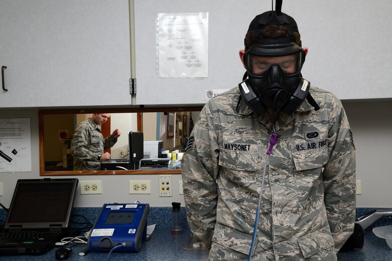 Staff Sgt. Nathan Maysonet, 47th Flying Training Wing public affairs photojournalist, completes his fit test for the M50 chemical protective mask at the 47th Medical Operations Squadron Bioenvironmental Engineering office on Laughlin Air Force Base, Texas, Jan. 12, 2015. The fit test requires the user to don their own mask and perform a series of exercises that simulate typical activities to ensure the mask fits properly and provides a good seal. (U.S. Air Force photo by Airman 1st Class Ariel D. Delgado)