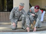 Florida's Assistant Adjutant General for Air Brig. Gen. James Eifert, left, and Joint Communications Support Element Commander Col. Kirby Watson place a memorial brick in front of the 290th Joint Communications Support Squadron (JCSS) headquarters at MacDill Air Force Base, Fla., Jan. 13, 2015. 