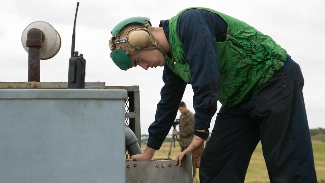 Lance Cpl. Ronald Summerlin adjusts flight line equipment during arrested landing safety training Jan. 9 on Marine Corps Air Station Futenma. Arrested landings are the use of equipment, such as a safety barrier or an arresting wire, to rapidly decelerate an aircraft and ensure the landing path is straight and clear. During the training, Marines demonstrated proficiency in the use of arresting equipment while ensuring the safety of personnel and equipment on the airstrip. Summerlin is a Virginia Beach, Virginia, native and an expeditionary airfield systems technician with Headquarters and Headquarters Squadron, MCAS Futenma, Marine Corps Installations Pacific-Marine Corps Base Camp Butler, Japan. 