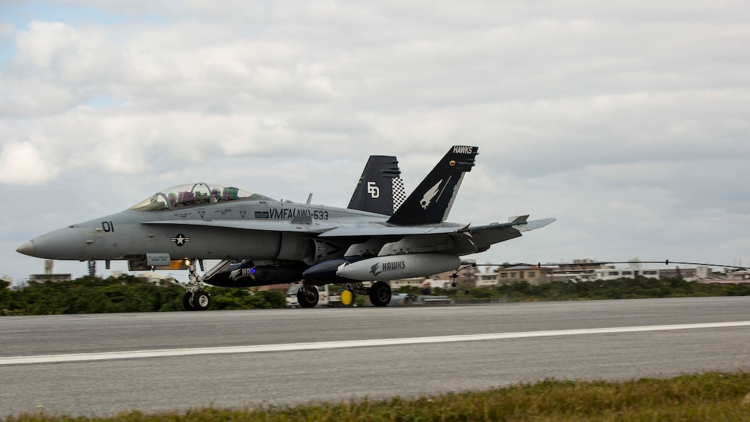 An FA-18D Hornet lands during arrested landing safety training Jan. 9 at Marine Corps Air Station Futenma. The equipment used in arrested landings help aircraft land within a limited distance, such as on an aircraft carrier. The Marines are expeditionary airfield systems technicians with Headquarters and Headquarters Squadron, MCAS Futenma, Marine Corps Installations Pacific-Marine Corps Base Camp Butler, Japan. The aircraft is with Marine All Weather Fighter Attack Squadron 533, Marine Aircraft Group 31, which is currently assigned to Marine Aircraft Group 12, 1st Marine Aircraft Wing, III Marine Expeditionary Force, under the unit deployment program. 