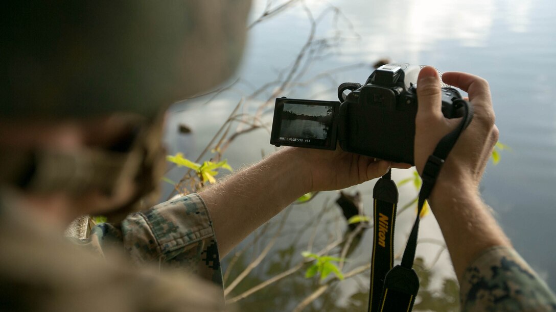 Sgt. Trevor McNally, from Hinckley, Minnesota, takes a photograph of a pool of water Jan. 13 at Camp Hansen as part of a Humanitarian Assistance Survey Team scenario. He has just identified a good source of fresh water that would prove useful to victims of a natural disaster. McNally is an engineer chief with Engineer Platoon, Combat Logistics Battalion 31, 31st Marine Expeditionary Unit. 