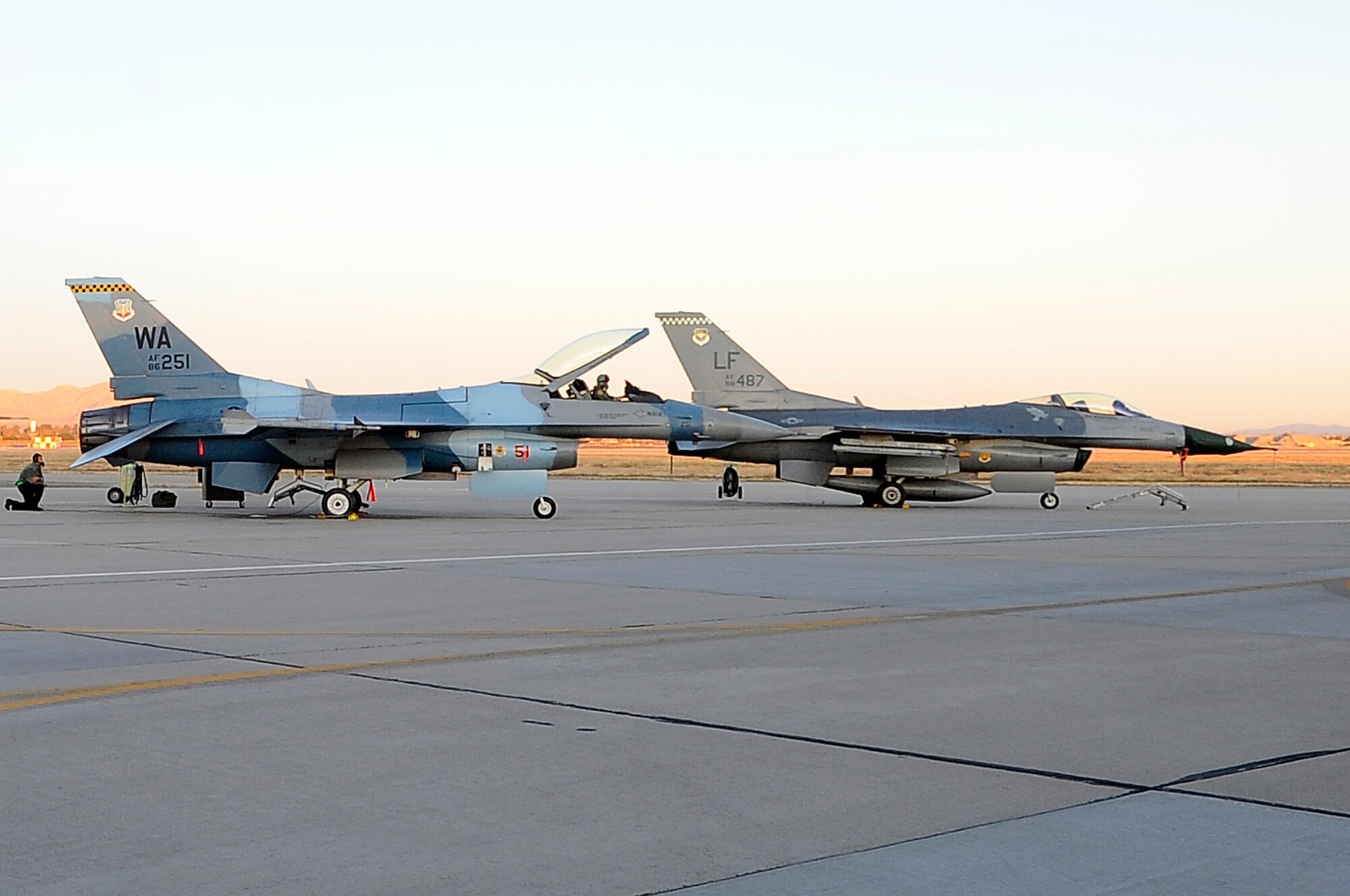 A 64th Aggressor Squadron F-16 Fighting Falcon and a 308th Fighter Squadron F-16 prepare for take-off during a simulated adversary flight training exercise at Luke Air Force Base, Arizona, Jan. 7, 2015. (U.S. Air Force photo/Airman Pedro Mota)
