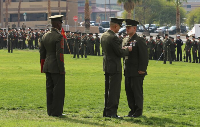 Lt. Col. Seth E. Yost, former battalion commander, 1st battalion, 7th Marine Regiment, a native of Wellsboro, Pa., receives a bronze star during the 1/7 change of command ceremony at Lance Cpl. Torrey L. Gray Field, Dec. 4, 2014. Yost received a bronze star for brave and praiseworthy service. (Official Marine Corps photo by Lance Cpl. Medina Ayala-Lo/Released)