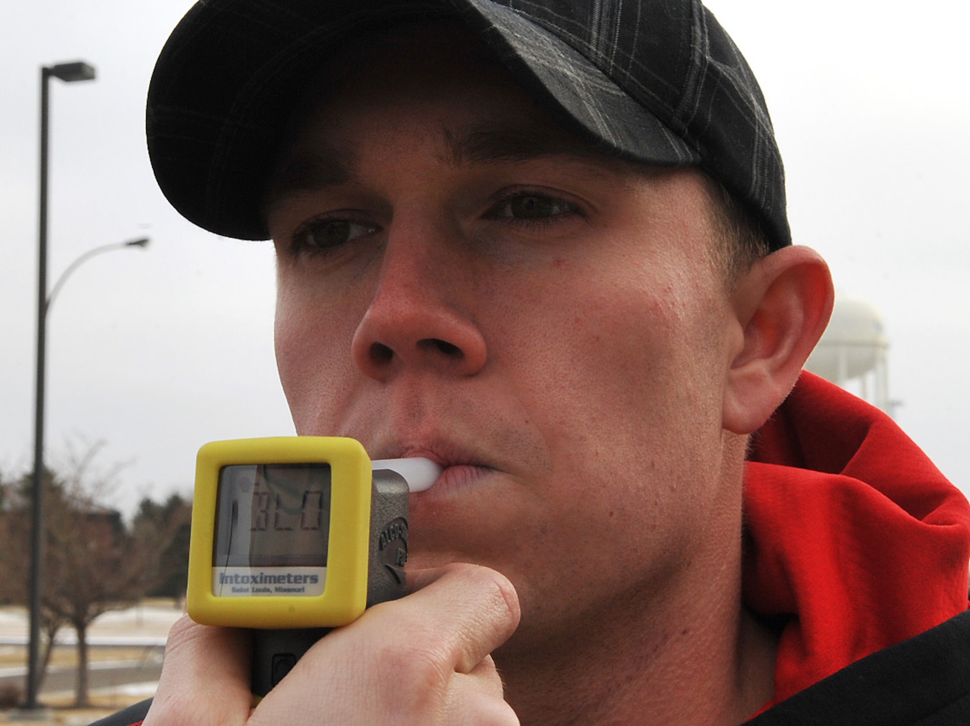 Airman Bryce Willsey demonstrates how a portable breath test (PBT) is used Dec. 10, 2014, on Grand Forks Air Force Base, N.D. A PBT is used to test a subject’s blood alcohol content when the subject is believed to be intoxicated while driving. Willsey is a 319th Security Forces Squadron alarm monitor. (U.S. Air Force photo/Airman 1st Class Bonnie Grantham)