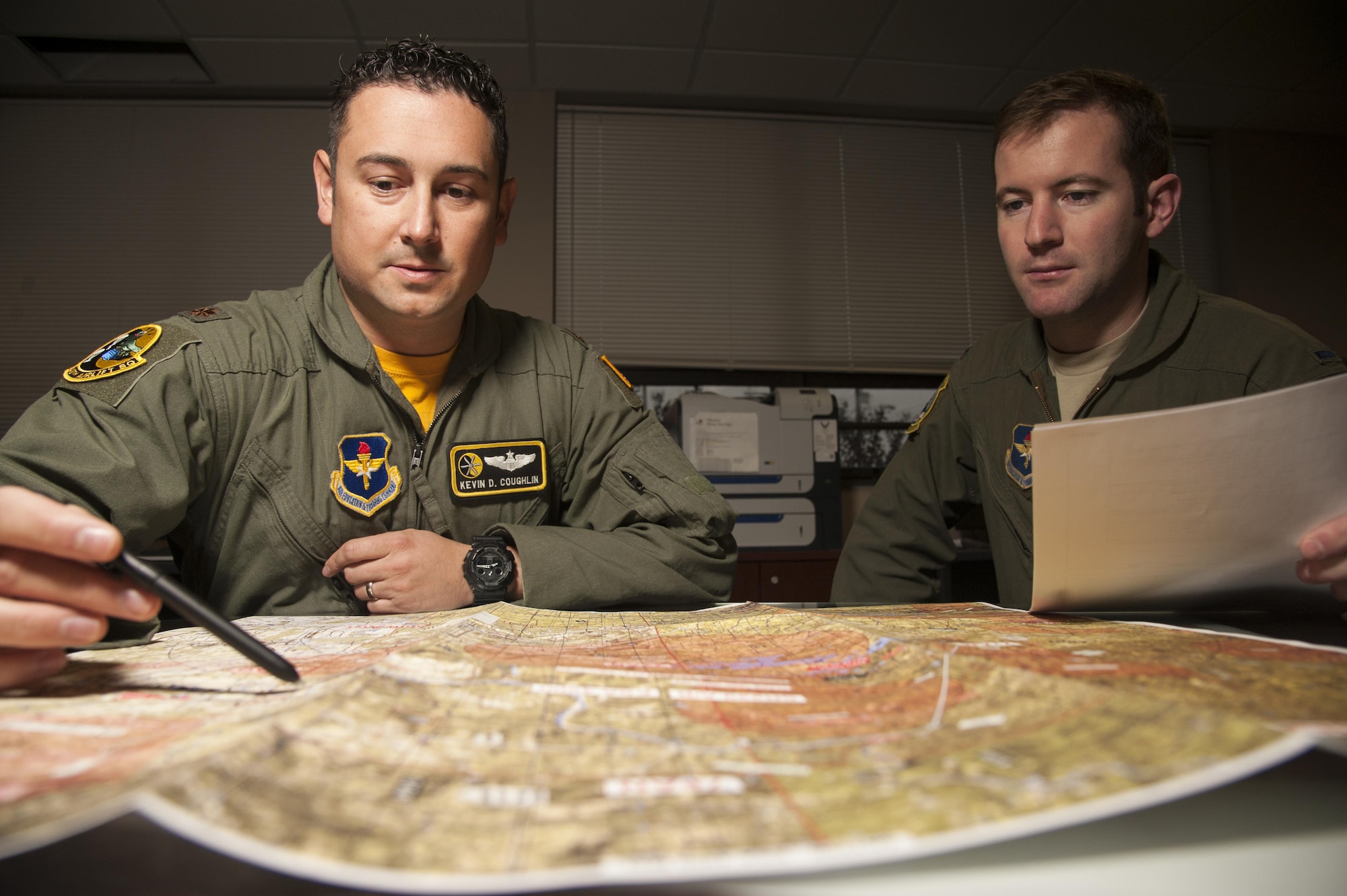 Maj. Kevin Coughlin reviews flight plans before a flight Nov. 20, 2014, at Little Rock Air Force Base, Ark. Coughlin spent time training Israeli aircrews on the Coordinated Aircraft Positioning (CAP) system and Station Keeping Equipment (SKE) formation operation systems. Coughlin is the 48th Airlift Squadron flight commander and an instructor pilot. (U.S. Air Force photo/Senior Airman Kaylee Clark) 