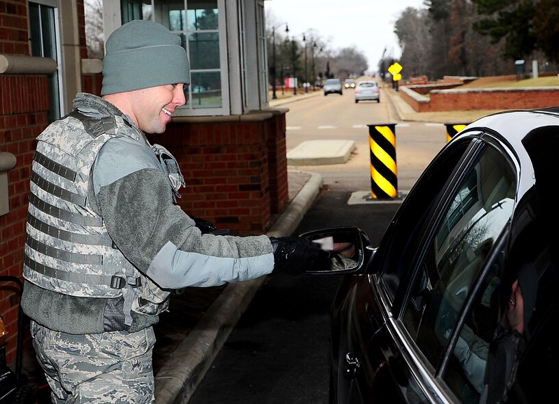 2nd Lt. Robert Reay, 14th Security Forces Squadron augmentee, checks identification of Team BLAZE members entering Columbus Air Force Base, Mississippi, Jan. 14. (U.S. Air Force photo/Airman Kaleb Snay)