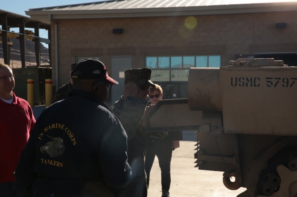 Kenny R. White, Marine veteran, native of San Diego, Calif., listens as Mathieu Brundige, tank crewman, 1st Tank Battalion, explains the functionalities of the M1A1 Abrams on the units tank ramp, Dec. 22, 2014. White served as a tank crewman for 17 years as a reservist in 4th Tank Battalion. (Official Marine Corps photo by Lance Cpl. Medina Ayala-Lo/Released)