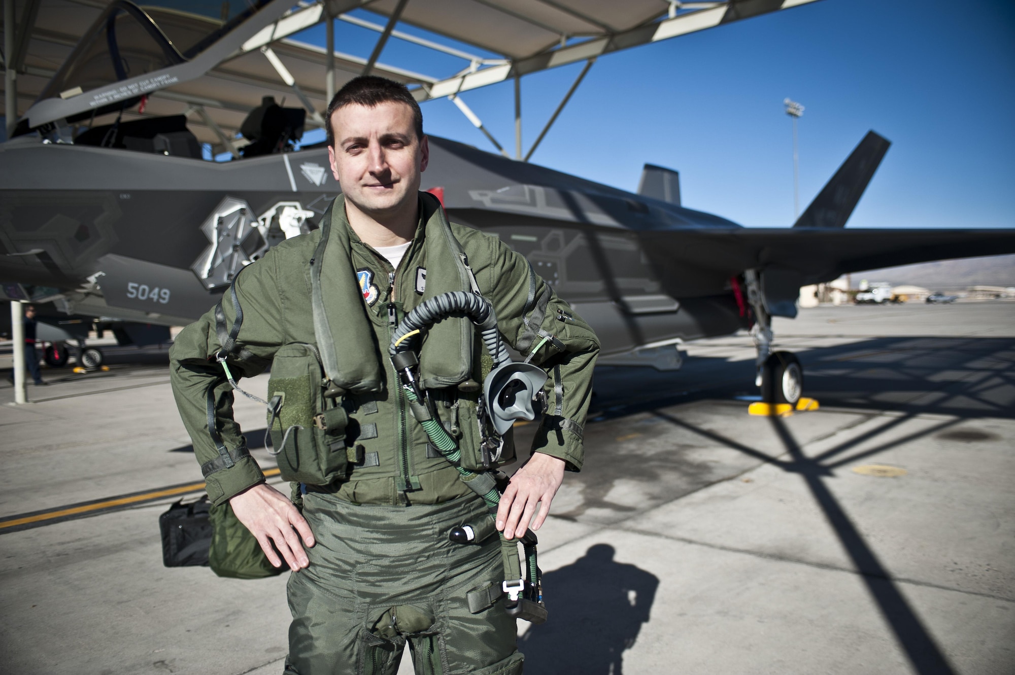 Capt. Brent Golden, 16th Weapons Squadron instructor, poses for a photo in front of the U.S. Air Force Weapons School’s first assigned F-35A Lightning II Jan. 15, 2015, at Nellis Air Force Base, Nev. Golden piloted the aircraft from Lockheed Martin’s plant in Fort Worth, Texas, to its new home at the USAFWS. (U.S. Air Force photo/Staff Sgt. Siuta B. Ika)