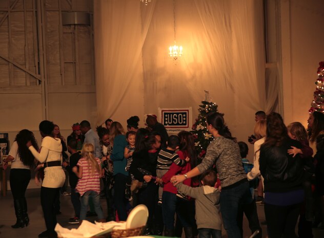 Staff members and their love ones enjoy the live music during the Bob Hope United Service Organization, Palm Springs sponsored Robert E. Bush Naval Hospital holiday party at Smith Ranch, Dec. 11, 2014. Throughout the night there were a variety of activities including multiple giveaways and a visit from Santa Claus. (Official Marine Corps photo by Lance Cpl. Medina Ayala-Lo/Released)