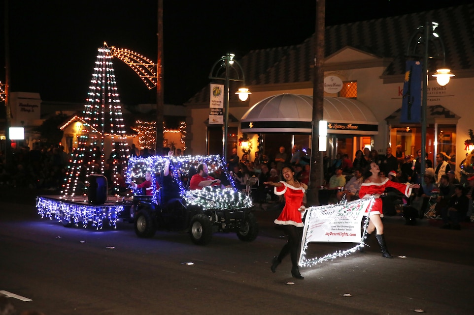 A float decorated in holiday themed lights rolls down the street playing music form the motion picture "Frozen" at the 23rd annual Festival of Lights Parade in Palm Springs, Calif., Dec. 6, 2014. More than 60,000 people attended the annual parade. (Official Marine Corps Photo by Lance Cpl. Julio McGraw/Released)