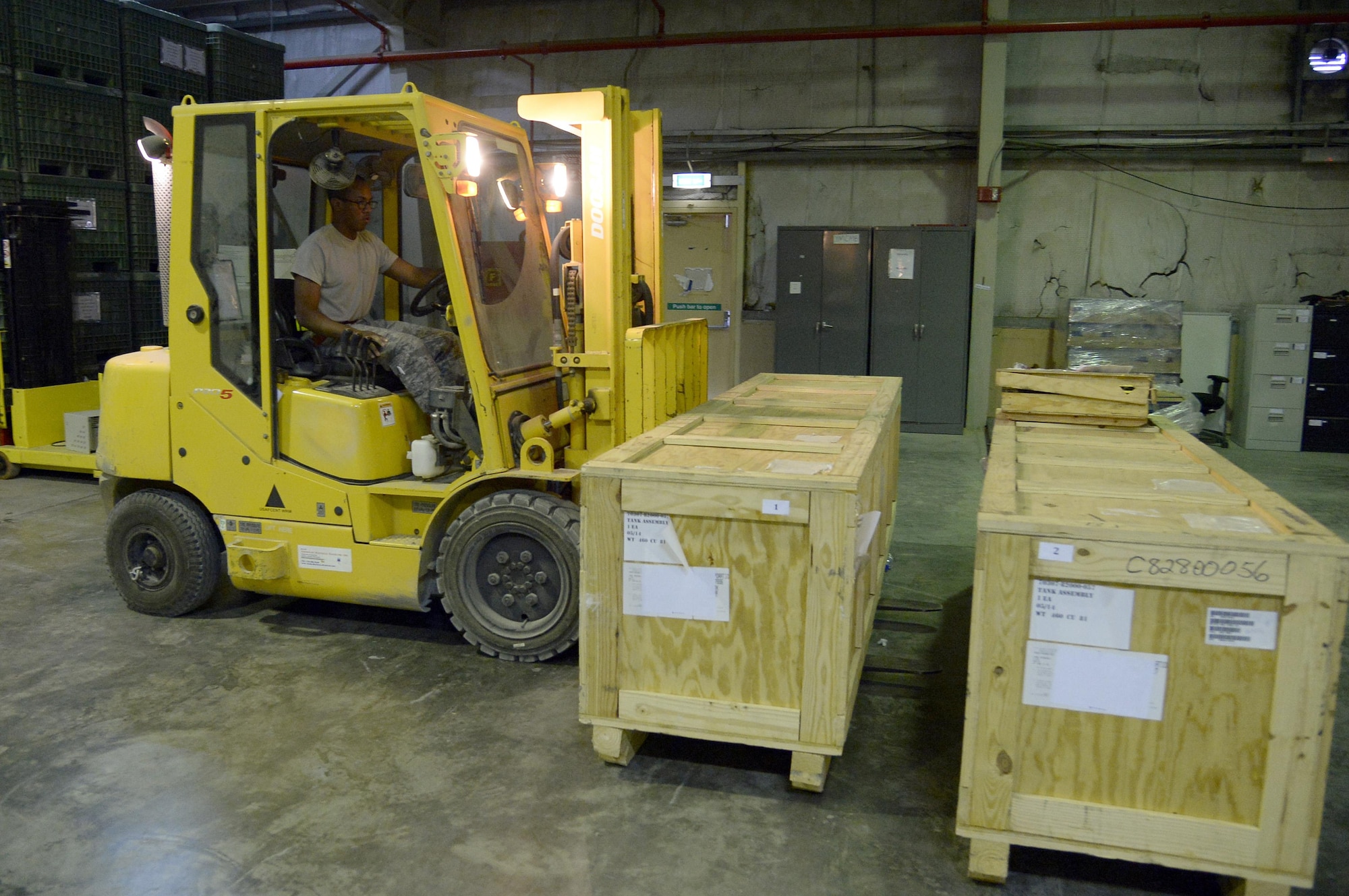 Airman 1st Class Kevin, Traffic Management journeyman, moves a crate inside the Traffic Management warehouse at an undisclosed location in Southwest Asia Jan. 14, 2015. Traffic Management Airmen use equipment ranging from wood-cutting saws to 10K all-terrain forklifts to prepare cargo for storage, shipment and delivery. Kevin is currently deployed from Luke Air Force Base, Ariz., and is a native of Trinidad and Tobago but call Brooklyn, N.Y. home. (U.S. Air Force photo/Tech. Sgt. Marie Brown)