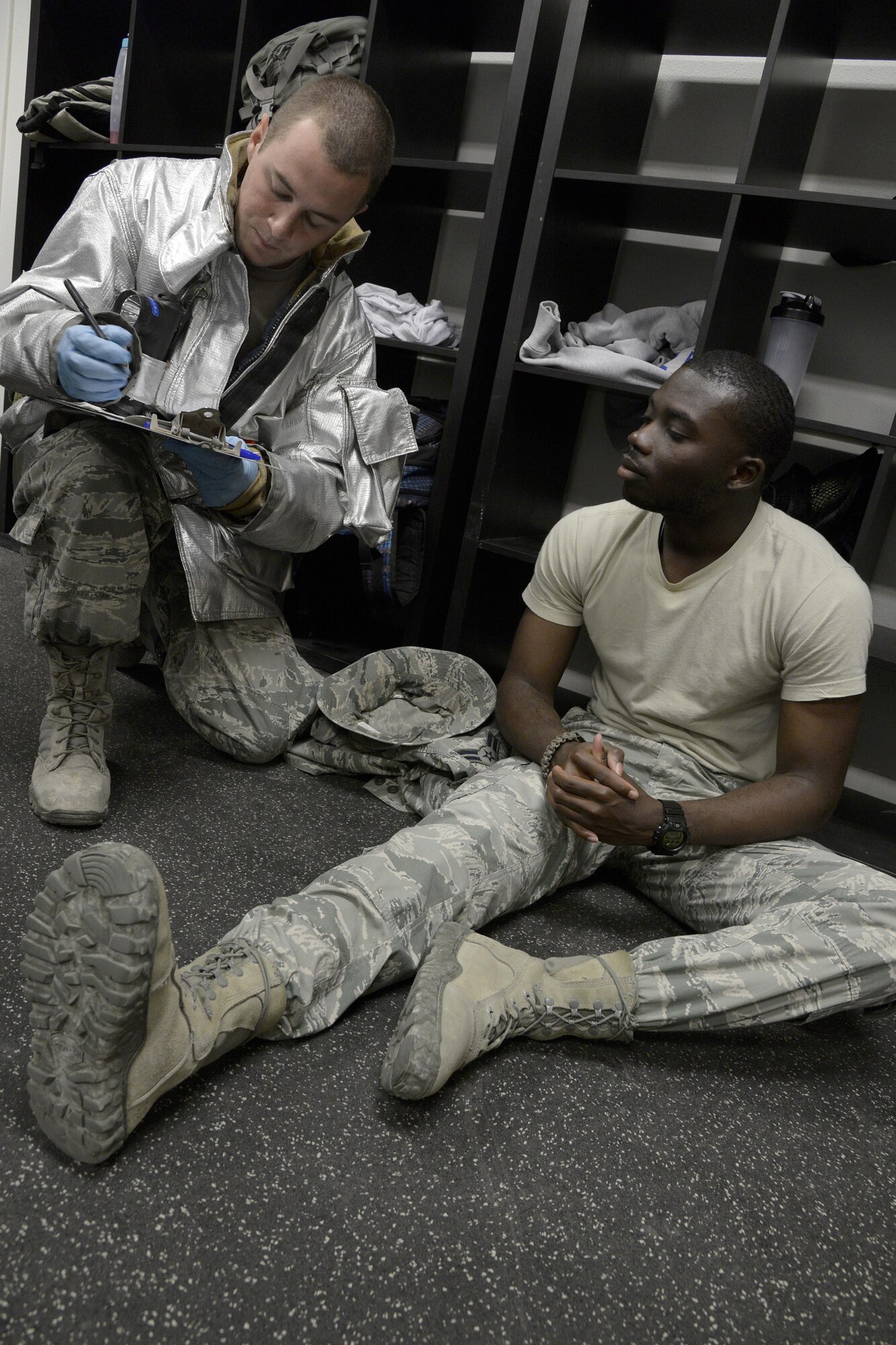 Senior Airman Austin, fire truck driver and operator, evaluates a simulated medical patient with a sprained ankle during a training exercise at an undisclosed location in Southwest Asia Jan. 15, 2015. The exercise tested the Air Expeditionary Wing’s Disease Containment Plan. Austin is currently deployed from Travis Air Force Base, Calif. and is a native of Twinfalls, Idaho.  (U.S. Air Force photo/Tech. Sgt. Marie Brown)