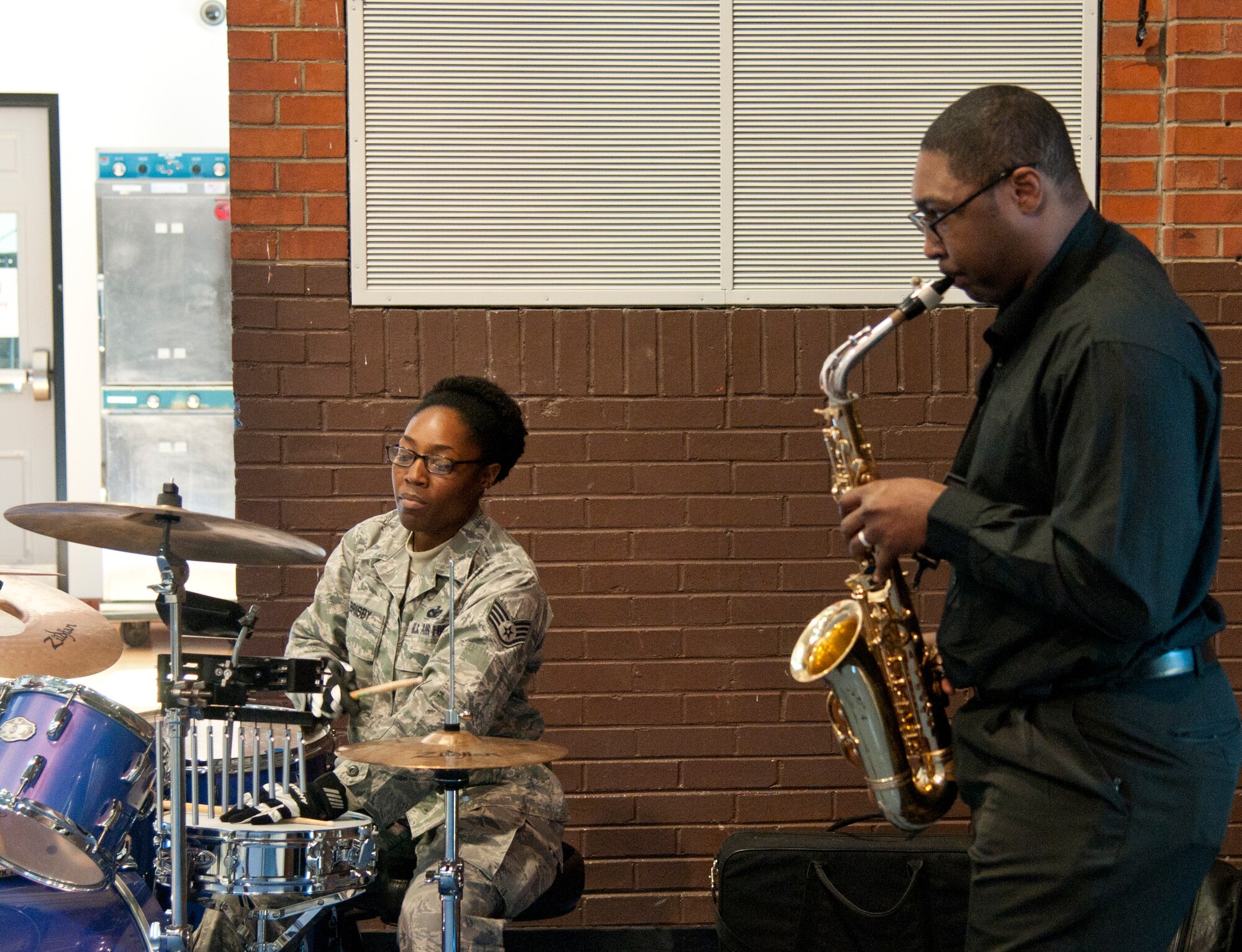 Staff Sgt. Curnita Brisby, 90th Security Forces Squadron Plans and Programs, and Staff Sgt. Christopher Banks, 90th SFS Military Working Dogs Section, play music during the 90th Missile Wing’s Dr. Martin Luther King, Jr., remembrance luncheon Jan. 15, 2015, in the Fall Hall Community Center on F.E. Warren Air Force Base, Wyo. The event celebrated King’s life and legacy. (U.S. Air Force photo by Senior Airman Jason Wiese)