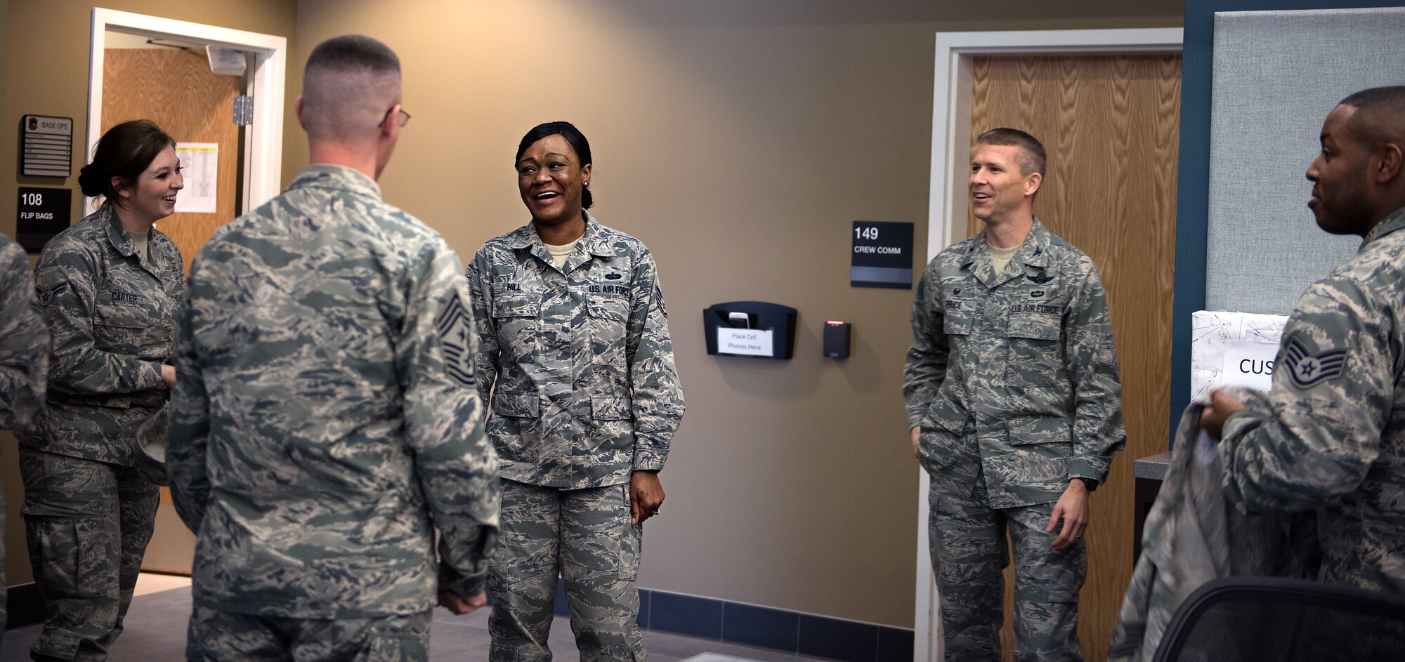 Tech. Sgt. Jessica Hill, 305th Operations Support Squadron combat crew communications section chief, laughs with 305th Air Mobilty Wing leaders and members of her unit after receiving a promotion as part of the Stripes for Exceptional Performers program Jan. 6, 2015 at Joint Base McGuire-Dix-Lakehurst. STEP promotions allow commanders a limited opportunity to immediately promote enlisted members and recognize Airmen who exhibit exceptional potential. (U.S. Air Force photo by Staff Sgt. Katherine Tereyama/RELEASED)
