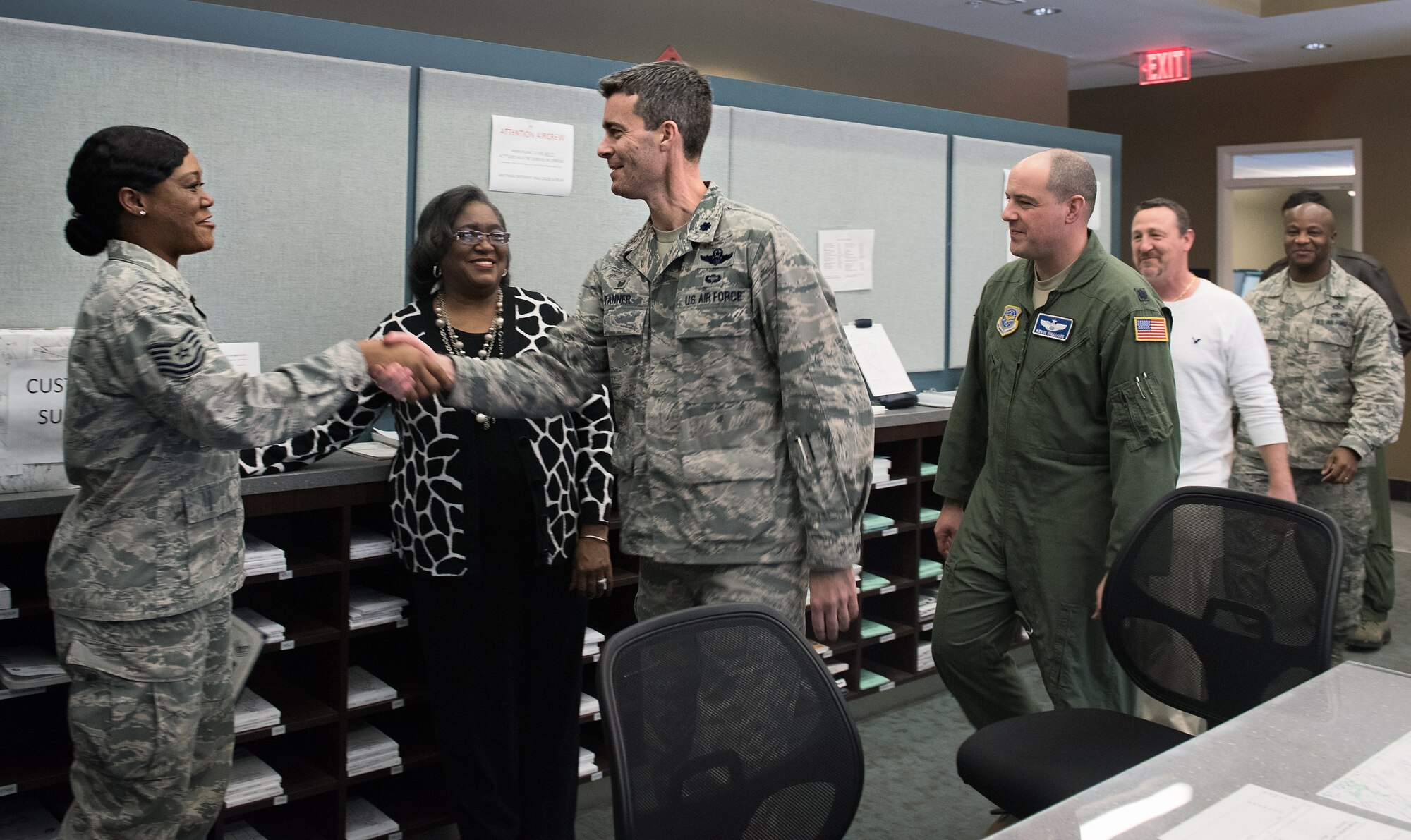 Lt. Col. Richard Tanner (right), 305th Operations Support Squadron commander, congratulates Tech. Sgt. Jessica Hill, 305th Operations Support Squadron combat crew communications section chief, on her promotion Jan. 6, 2015 at Joint Base McGuire-Dix-Lakehurst. Hill was promoted through the Stripes for Exception Performers program. (U.S. Air Force photo by Staff Sgt. Katherine Tereyama/RELEASED)
