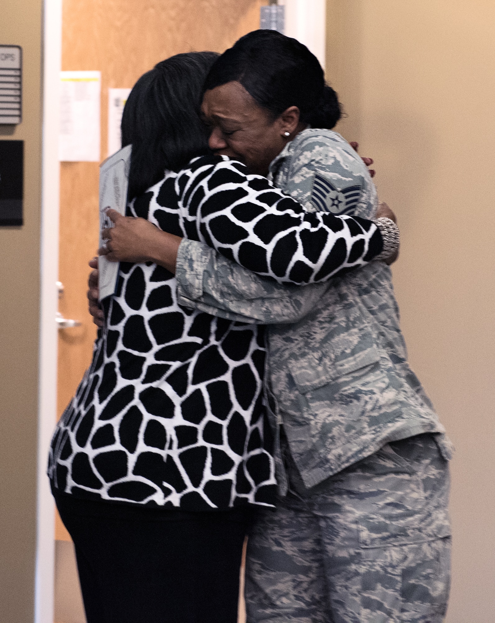 Newly promoted Tech. Sgt. Jessica Hill, 305th Operations Support Squadron combat crew communications section chief, hugs her mother, Jessie Stevenson, Jan. 6, 2015 at Joint Base McGuire-Dix-Lakehurst. Hill was promoted through the Stripes for Exception Performers program. (U.S. Air Force photo by Staff Sgt. Katherine Tereyama/RELEASED)