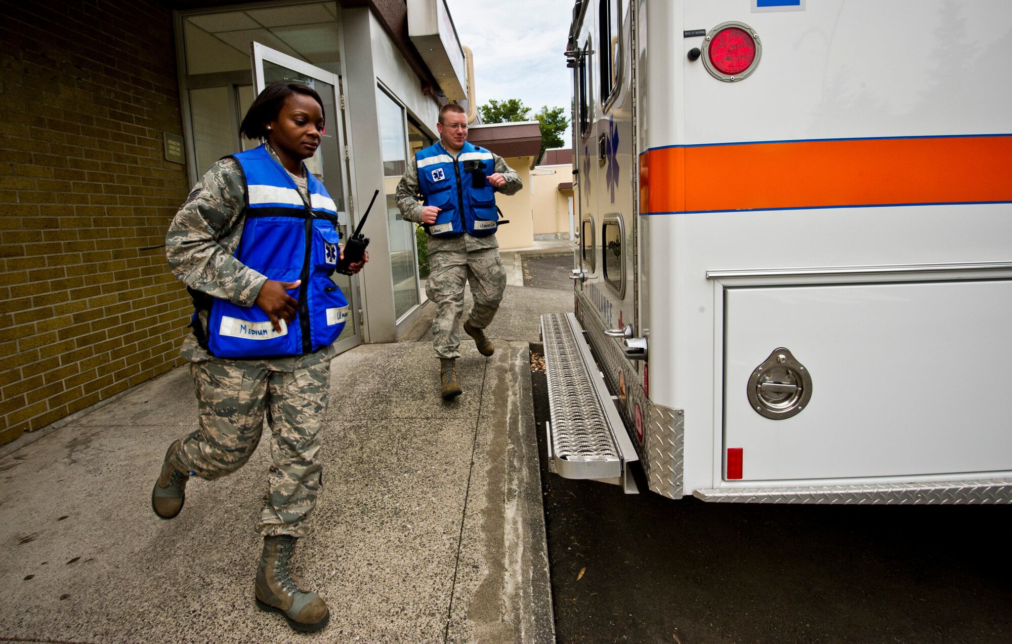 Staff Sgt. Raven Taylor (left) and Senior Airman Taylor Kanka, 374th Medical Operations Squadron medical technicians, race to an ambulance during a simulated 911 call to the Urgent Care Center at Yokota Air Base, Japan, July 8, 2011. Through the Stripes for Exceptional Performers (STEP), Taylor was awarded the rank of technical sergeant for her impact on the Air Force during her career. She was selected alongside only seven other Airmen in Air Combat Command to be STEP promoted at the end of the year. (U.S. Air Force photo/Staff Sgt. Samuel Morse)