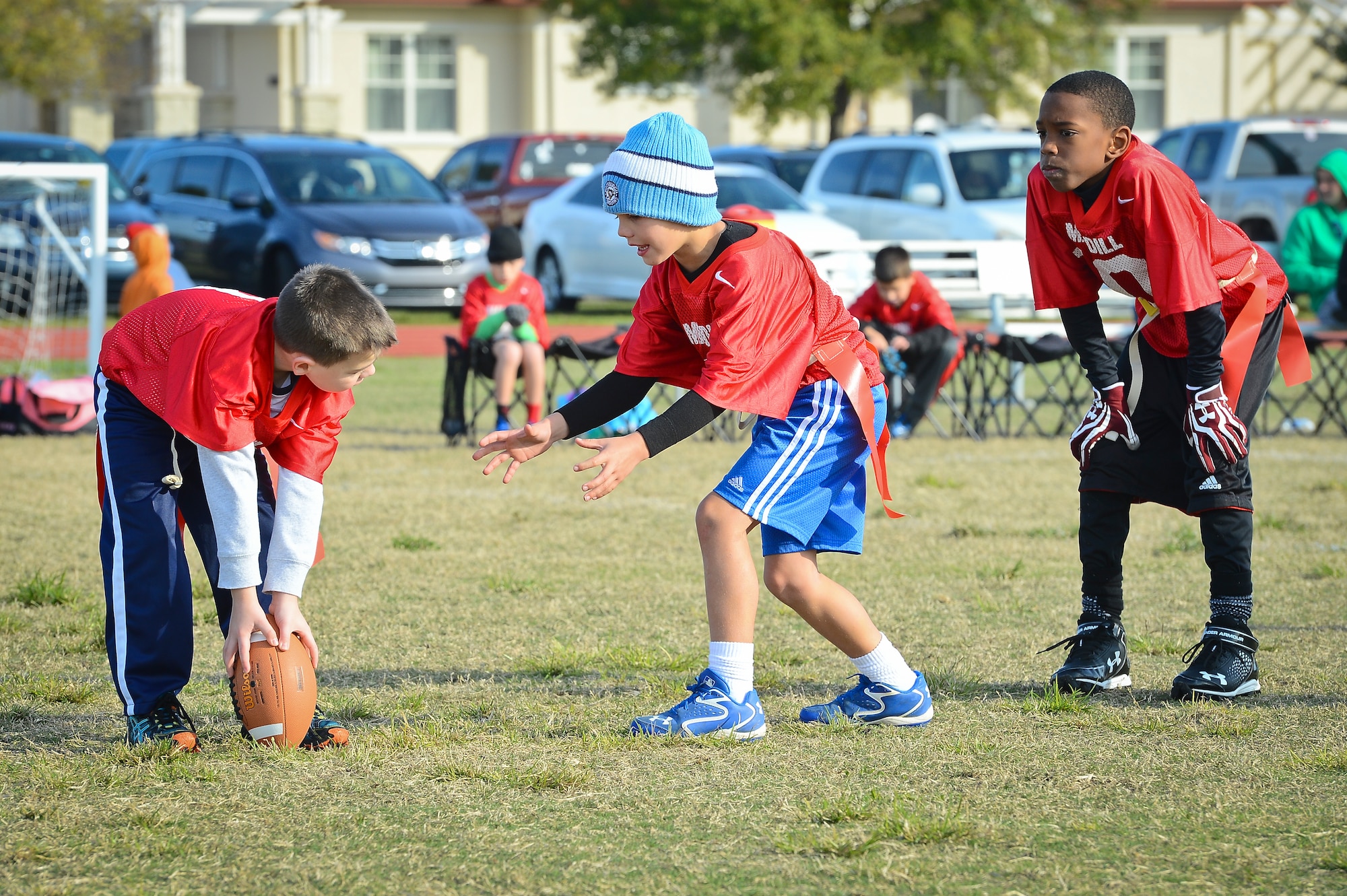 Children play flag football as part of the youth program’s inaugural flag football season at MacDill Air Force Base, Fla., January 10, 2015. The youth program ensures the fields are maintained before every Saturday game, as well as paints the field, places the end zone pylons and trains referees to officiate the games. (U.S. Air Force photo by Senior Airman Ned T. Johnston/Released)