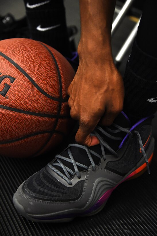 Staff Sgt. Troy Massey, Air Force District of Washington power forward, unties his shoes after an intramural game at the West Fitness Center on Joint Base Andrews, Md., Jan. 12, 2015. Massey plays for AFDW who are currently tied for fourth and contending for a playoff spot. (U.S. Air Force photo/Airman 1st Class Philip Bryant)