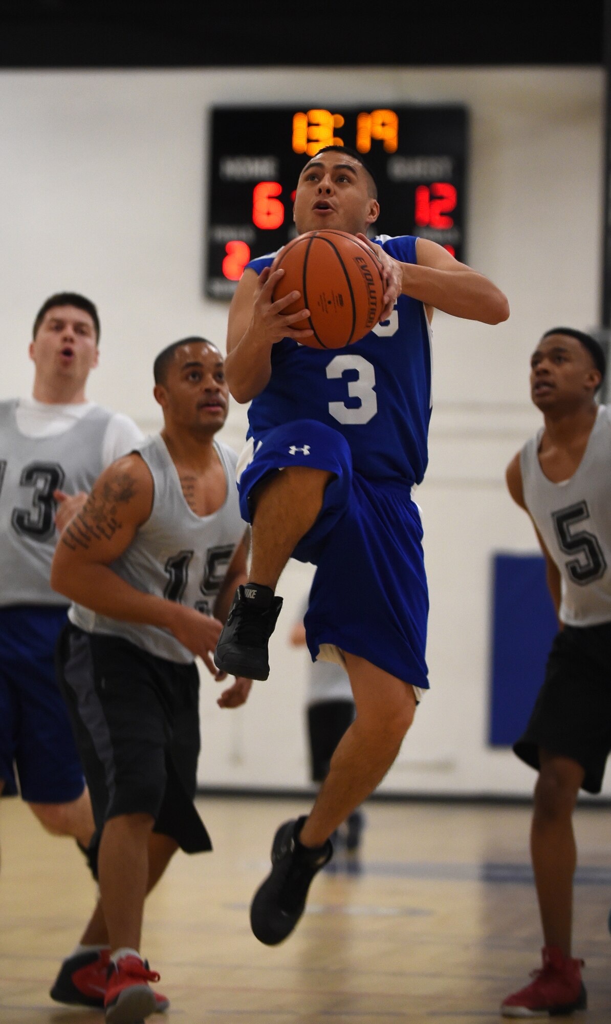 Tech. Sgt. Isaac Ibarra, Presidential Air Group point guard, make a fast break to the rim during an intramural game at the West Fitness Center on Joint Base Andrews, Md., Jan. 15, 2015. Ibarra and PAG lost the game to 89th Aerial Port Squadron, 45-38. (U.S. Air Force photo/Airman 1st Class Philip Bryant)