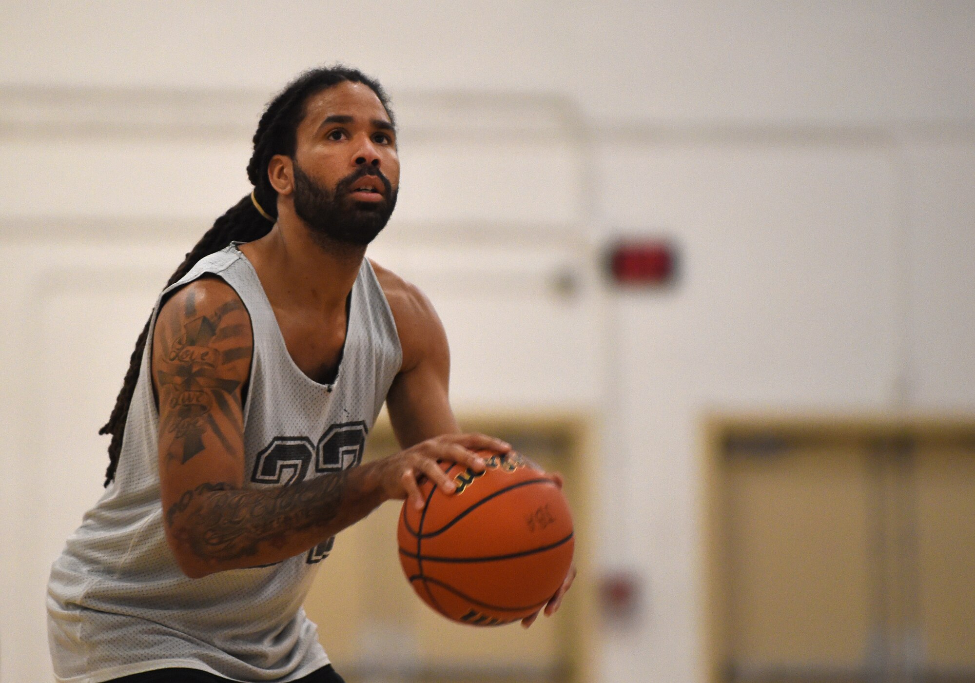 A.J. Kimpson, Air National Guard point guard, looks toward the basket as he prepares to take a free throw shot during an intramural game at the West Fitness Center on Joint Base Andrews, Md., Jan. 14, 2015. Kimpson made the free-throw and brought his team within four points of the opposing team, 459th Air Refueling Wing. (U.S. Air Force photo/Airman 1st Class Philip Bryant)