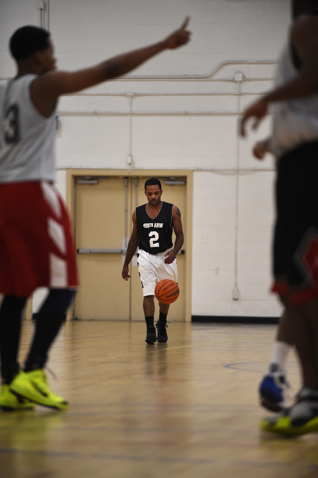 Senior Airman Wayne Booth, 459th Air Refueling Wing point guard, walks up the court with the ball during an intramural game at the West Fitness Center on Joint Base Andrews, Md., Jan. 14, 2015. Booth is a crew chief with the ARW, but finds time to play for their intramural team Mondays and Wednesdays. (U.S. Air Force photo/Airman 1st Class Philip Bryant)