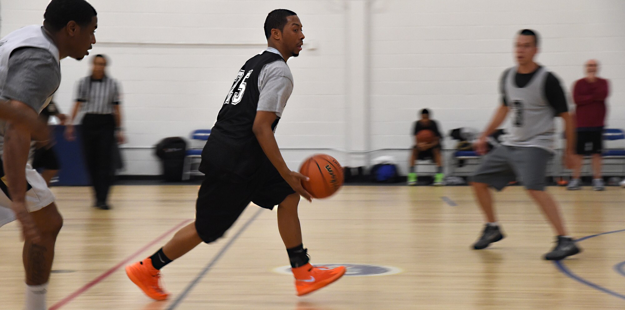 Calvin Simpson, Air National Guard point guard, dribbles the ball up the court during an intramural game at the West Fitness Center on Joint Base Andrews, Md., Jan. 12, 2015. Simpson is a military dependent and a recreation specialist who joined the ANG team to play some basketball on his free time. (U.S. Air Force photo/Airman 1st Class Philip Bryant)