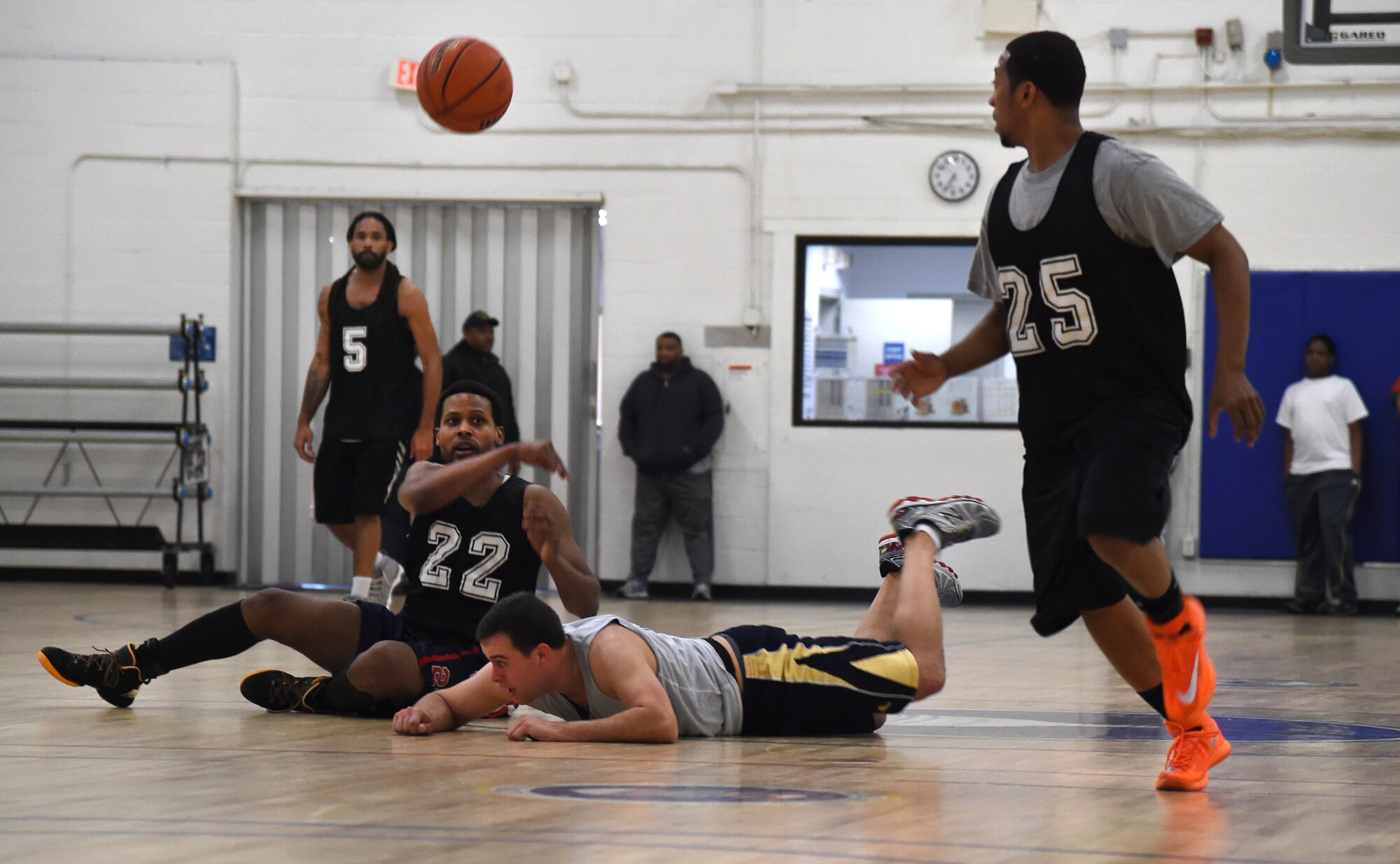 Jeffrey Ulyse, Air National Guard forward, passes the ball to Calvin Simpson, ANG point guard, during an intramural game at the West Fitness Center on Joint Base Andrews, Md., Jan. 12, 2015. Simpson went on to lay the ball up with no defender, playing part of a winning effort for ANG. Their win put their record at 6-1. (U.S. Air Force photo/Airman 1st Class Philip Bryant)