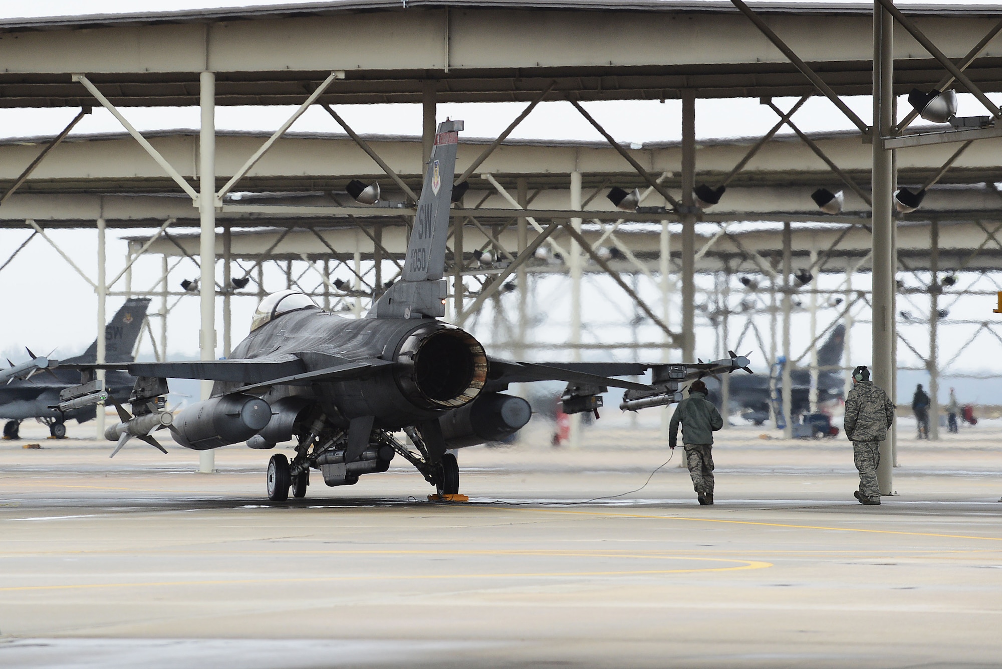 A U.S. Air Force Airman assigned to the 20th Aircraft Maintenance Squadron inspects an F-16CM Fighting Falcon during a surge at Shaw Air Force Base, S.C., Jan. 13, 2015. The 20th AMXS Airmen worked increased day and night operations during a five-day surge of sorties to maintain readiness. (U.S. Air Force photo by Airman 1st Class Diana M. Cossaboom/Released)