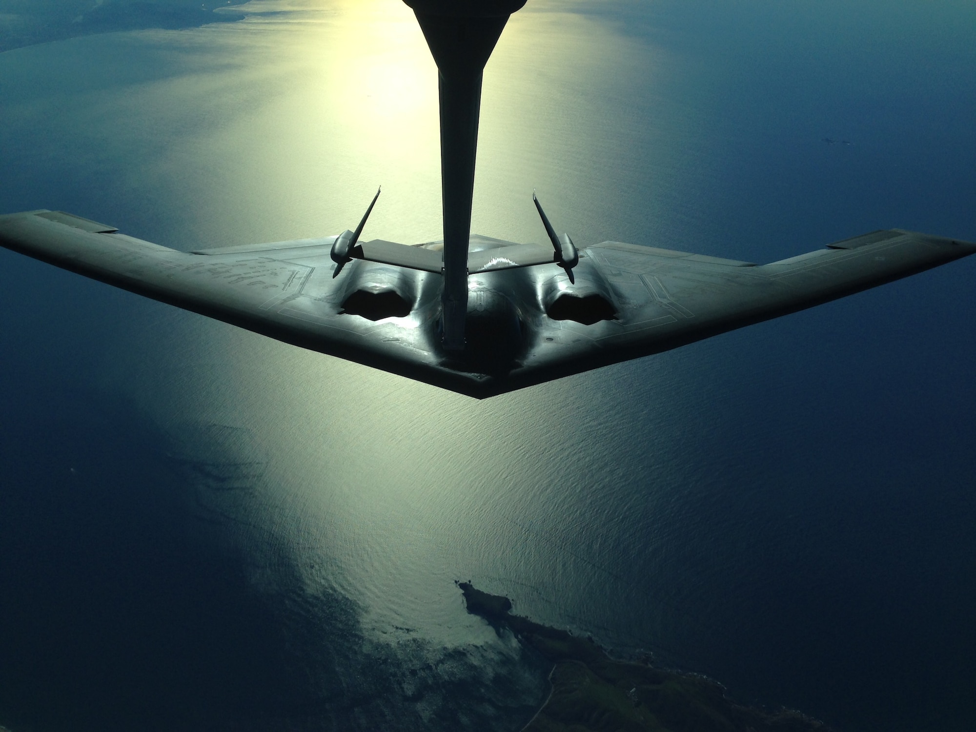 A B-2 Spirit from Whiteman Air Force Base, Missouri, conducts an aerial refuel by a 9th Air Refueling Squadron KC-10 Extender Jan. 1, 2015, along the California coastline. (U.S. Air Force photo by Senior Airman Laurel Cummins) 