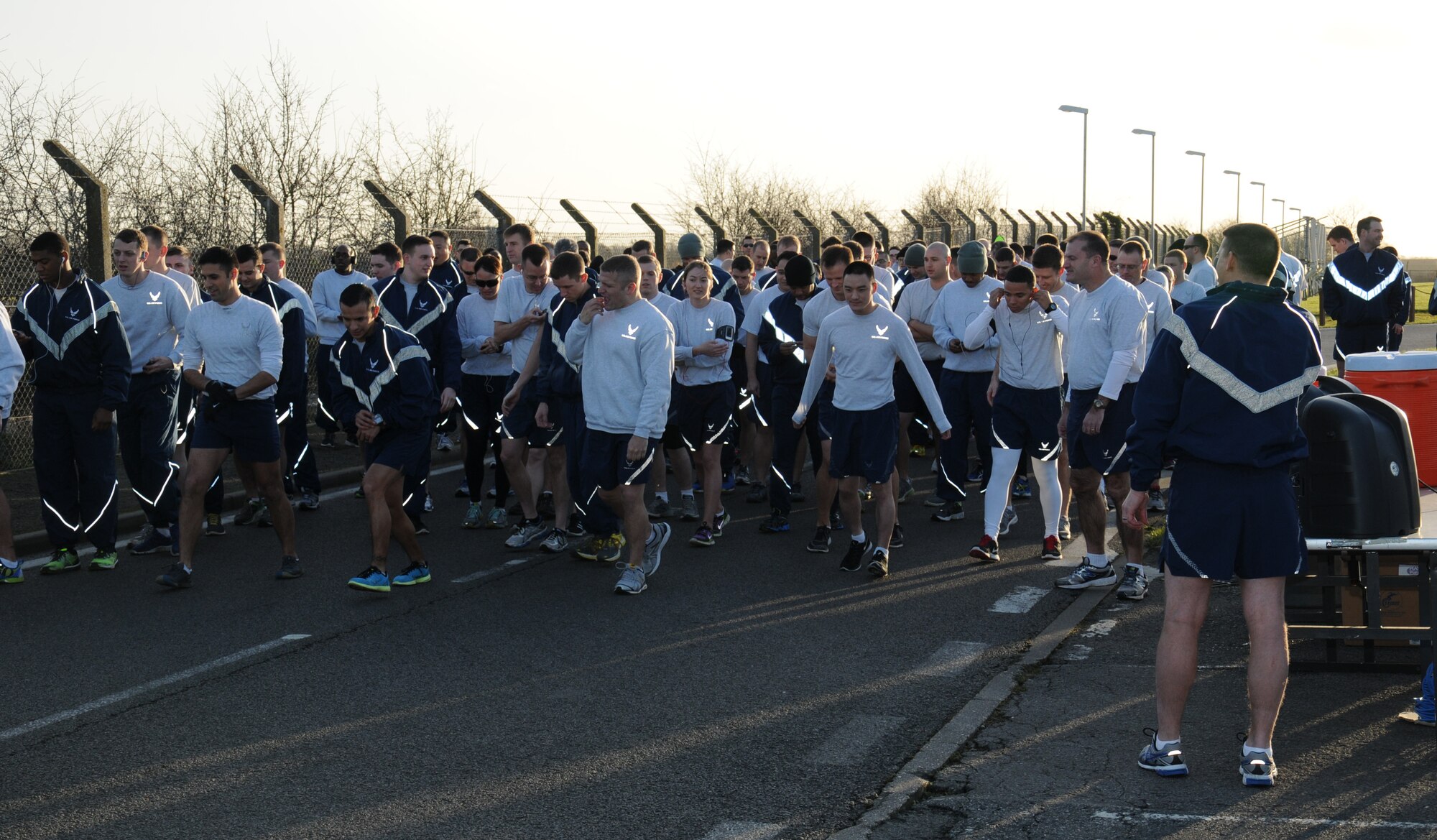 Team Mildenhall members prepare to start a monthly wing run Jan. 16, 2015, near the Hardstand Fitness Center on RAF Mildenhall, England. The monthly 5k run brings together many units on base through exercise and healthy competition. (U.S. Air Force photo by Gina Randall/Released)