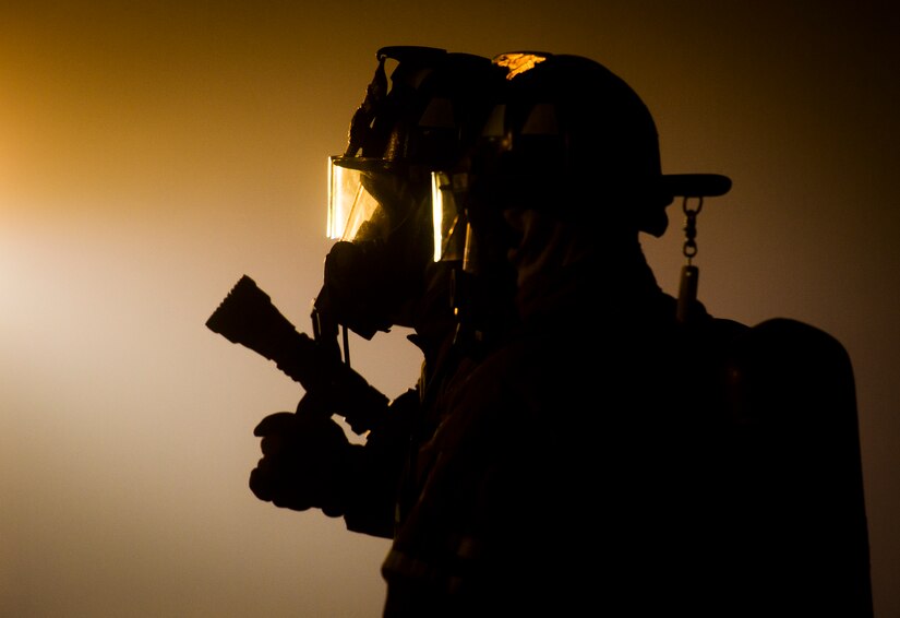 The 628th Civil Engineer Squadron Fire Department Airmen aim a fire hose at a structural fire Jan. 12, 2015, at Joint Base Charleston, S.C during a live-fire training exercise. Local fire departments came to the base and trained with the Airmen and shared their experiences and knowledge of firefighting. (U.S. Air Force photo/ Senior Airman Dennis Sloan) 