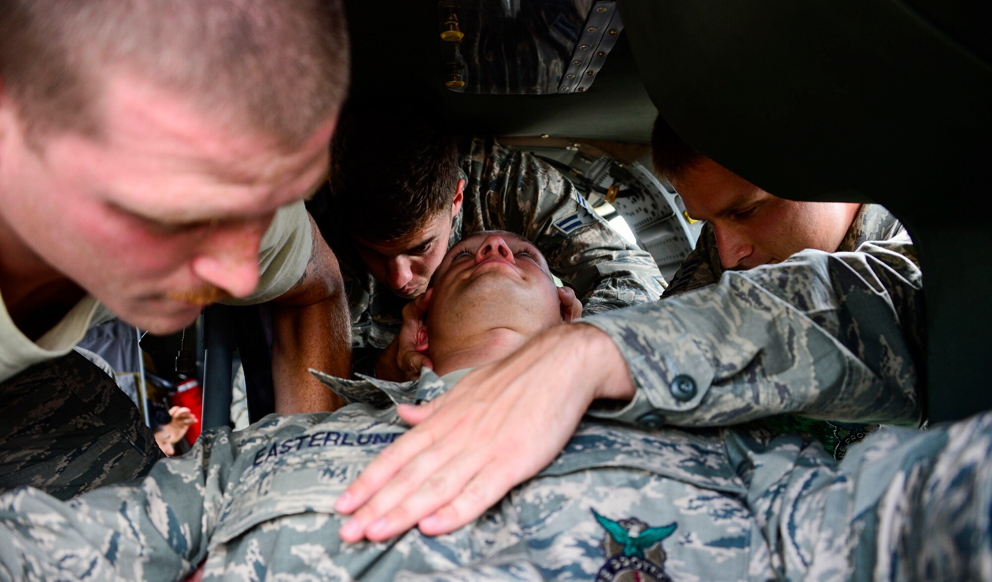 Members from the 612th Air Base Squadron Fire Department work together to extract U.S. Air Force Staff Sgt. Daniel Easterlund, 612th Air Base Squadron firefighter, from a UH-60 Blackhawk helicopter during aircraft crash rescue training at Soto Cano Air Base, Honduras, Jan. 15, 2015.  At least once a quarter, the 612th ABS teams up with the 1-228th Aviation Regiment to review aircraft crash rescue training and emergency procedures for the UH-60 Blackhawk helicopter. (U.S. Air Force photo/Tech. Sgt. Heather Redman)