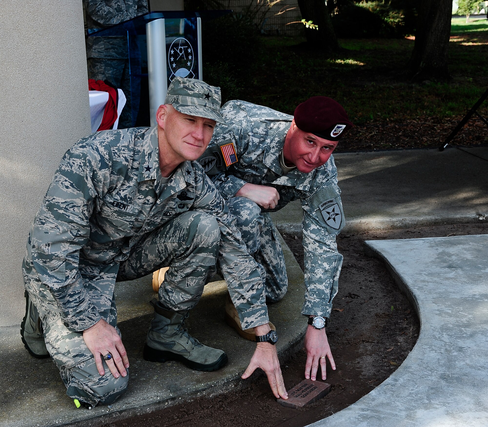 Brig. Gen. James Eifert, the Assistant Adjutant General-Air and Deputy Commander of the Florida Air National Guard, and Col. Kirby Watson, Joint Communications Support Element commander, place the first brick during the 290th Joint Communications Support Squadron’s brick dedication ceremony at MacDill Air Force Base, Fla., Jan. 14, 2015. The brick is the first of many that will be used to create the 290th JCSS’ brick garden. (U.S. Air Force photo by Senior Airman Vernon L. Fowler Jr./Released)