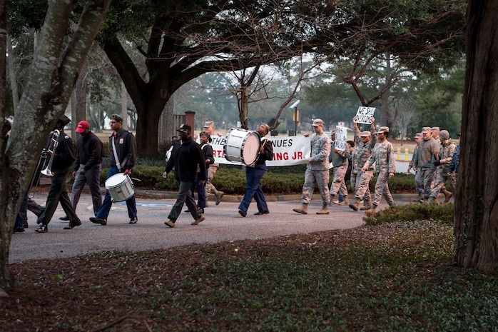Military Magnet Academy High School marching band members and Airmen honor Martin Luther King Jr., during  a memorial march Jan. 16, 2015, at Joint Base Charleston, S.C.  Following the march a celebratory program was held inside the chapel, with guest speaker Doug Hunter, the executive director of the Whitfield Center for Christian Leadership at Charleston Southern University. Martin Luther King Jr. Day is a federal holiday that celebrates his life and achievements as an influential leader of the American Civil Rights Movement.   (U.S. Air Force photo/Senior Airman Jared Trimarchi)  )  