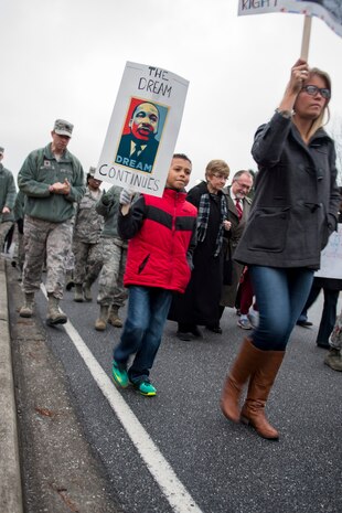 Family members, civilians and Airmen walk during a memorial march commemorating Martin Luther King Jr., Jan. 16, 2015, at Joint Base Charleston, S.C. Following the march a celebratory program was held inside the chapel, with guest speaker Doug Hunter, the executive director of the Whitfield Center for Christian Leadership at Charleston Southern University. Martin Luther King Jr. Day is a federal holiday that celebrates his life and achievements as an influential leader of the American Civil Rights Movement.   (U.S. Air Force photo/Senior Airman Jared Trimarchi)  