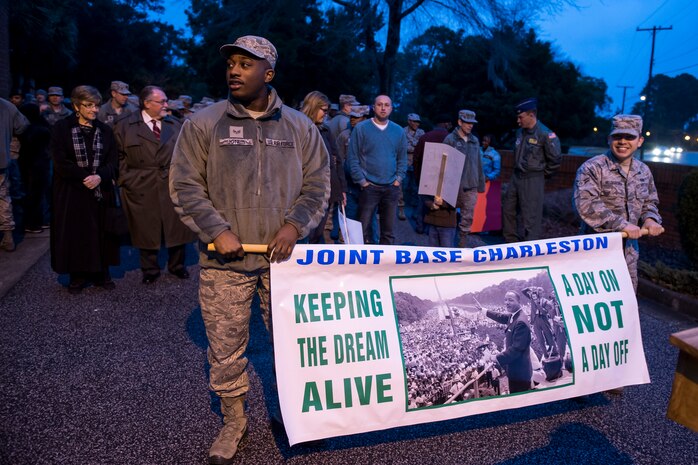 More than 100 Airmen, Sailors ,service members, civilians and family members prepare for the start of a memorial march commemorating Martin Luther King Jr., in front of the base chapel Jan. 16, 2015, at Joint Base Charleston, S.C. Following the march a celebratory program was held inside the chapel, with guest speaker Doug Hunter, the executive director of the Whitfield Center for Christian Leadership at Charleston Southern University. Martin Luther King Jr. Day is a federal holiday that celebrates his life and achievements as an influential leader of the American Civil Rights Movement.   (U.S. Air Force photo/Senior Airman Jared Trimarchi)  