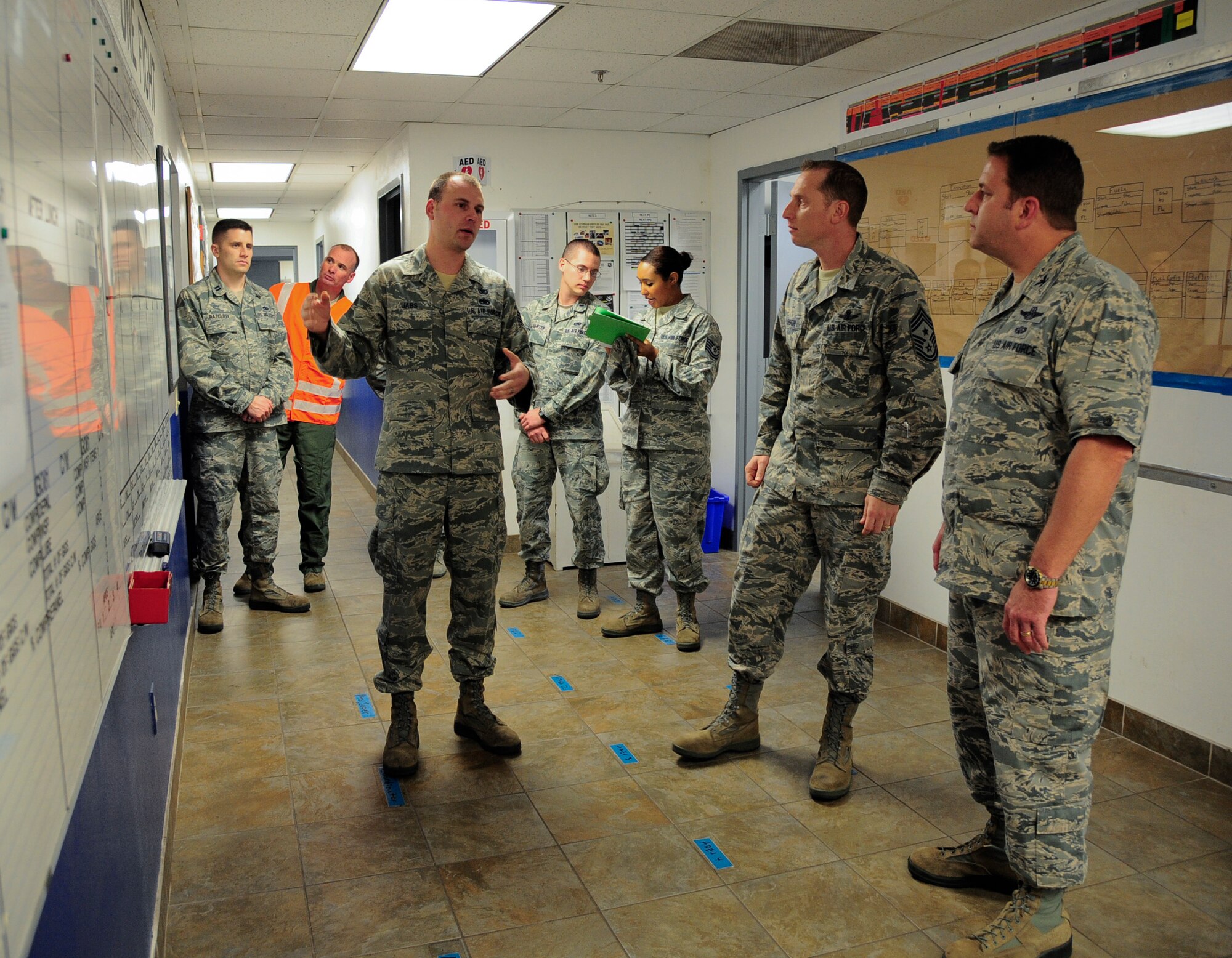 Tech Sgt. Christopher Jabs, 6th Maintenance Squadron periodic inspection coordinator,  explains to Chief Master Sgt. Matthew Lusson, 6th Air Mobility Wing command chief, and Col. Andre Briere, 6th AMW vice commander, the briefing system they have established at MacDill Air Force Base, Fla., Jan. 12, 2015. The process was an example of the fifth “S” of the 6S initiative, standardize. (U.S. Air Force photo by Airman 1st Class Danielle Conde/Released)