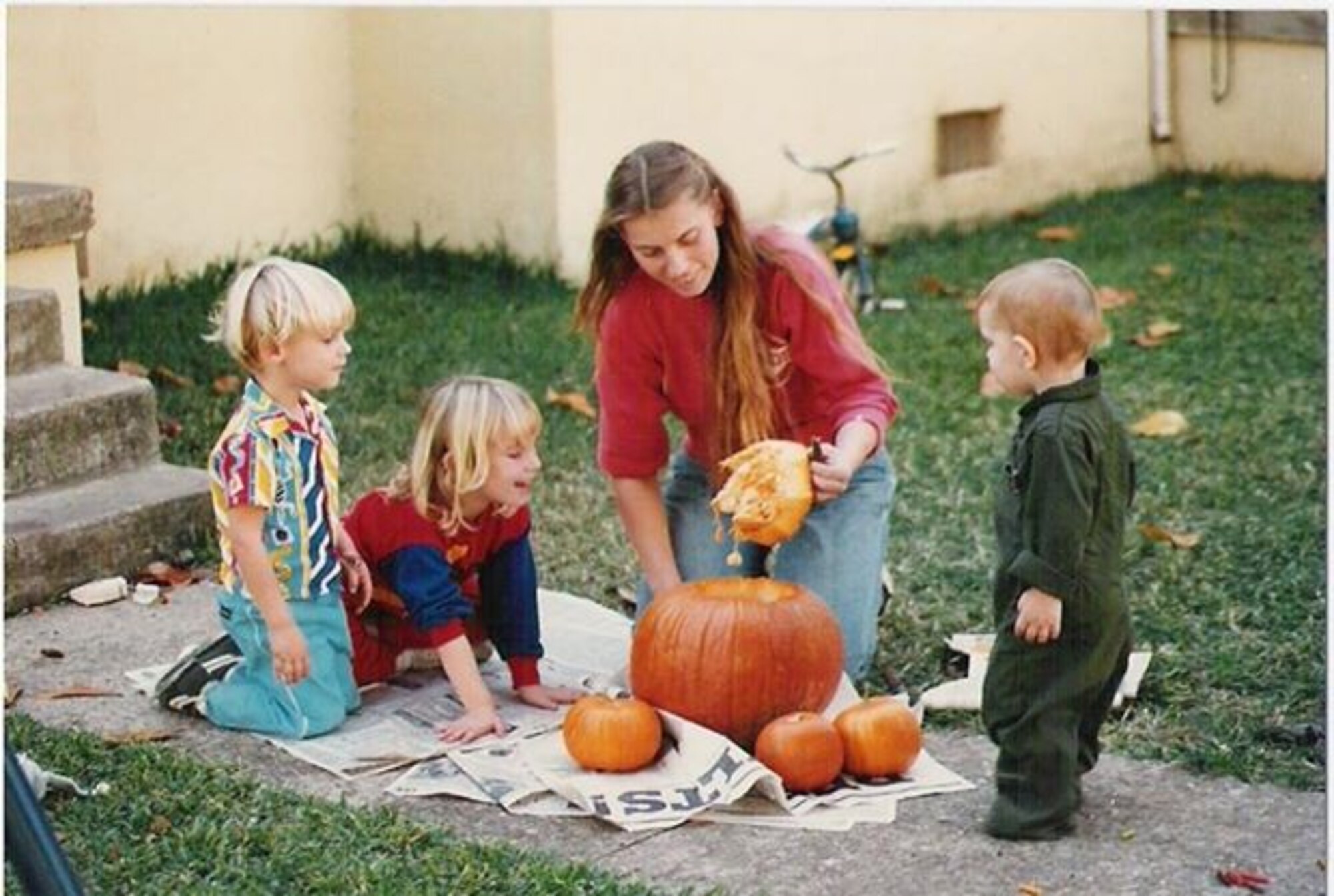 Tech. Sgt. Melena Quetel, 46th Aerial Port Squadron education and training manager, carves pumpkins with her children while stationed at Barksdale, La., in 1987. During this duty assignment, Quetel began taking classes toward earning a Community College of the Air Force degree. (Courtesy photo)