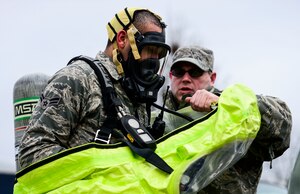 U.S. Air Force Master Sgt. Robert Stewart, 192nd Mission Support Group emergency management technician, assists Airman 1st Class Wesley Michaux, 192nd Mission Support Group emergency management technician, with donning a hazardous material suit during Integrated Base Emergency Response and Capability training at Langley Air Force Base, Va., Jan. 13, 2015. The training was designed to enhance Joint Base Langley-Eustis’ chemical, biological, radiological, nuclear and high-yield explosives response capabilities. (U.S. Air Force photo by Senior Airman Kayla Newman/Released) 