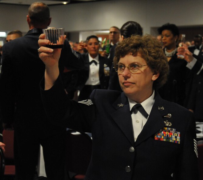 Tech. Sgt. Melena Quetel raises her glass as part of the Senior NCO Induction Ceremony April 5, 2014, in Dover, Del. Quetel became the first of 11 children in her family to earn a college degree when she graduated from the Community College of the Air Force Dec. 6, 2014, on Dover Air Force Base, Del. (U.S. Air Force photo/Senior Airman Joe Yanik)
